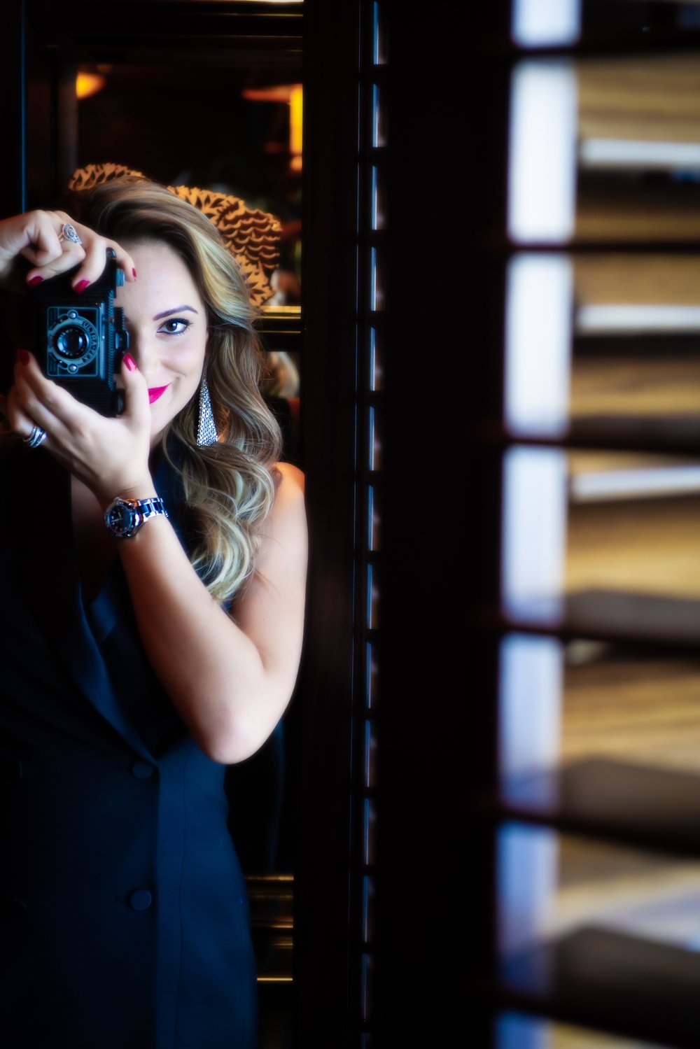Oana Turcan, founder of Onix Production, holding a vintage camera