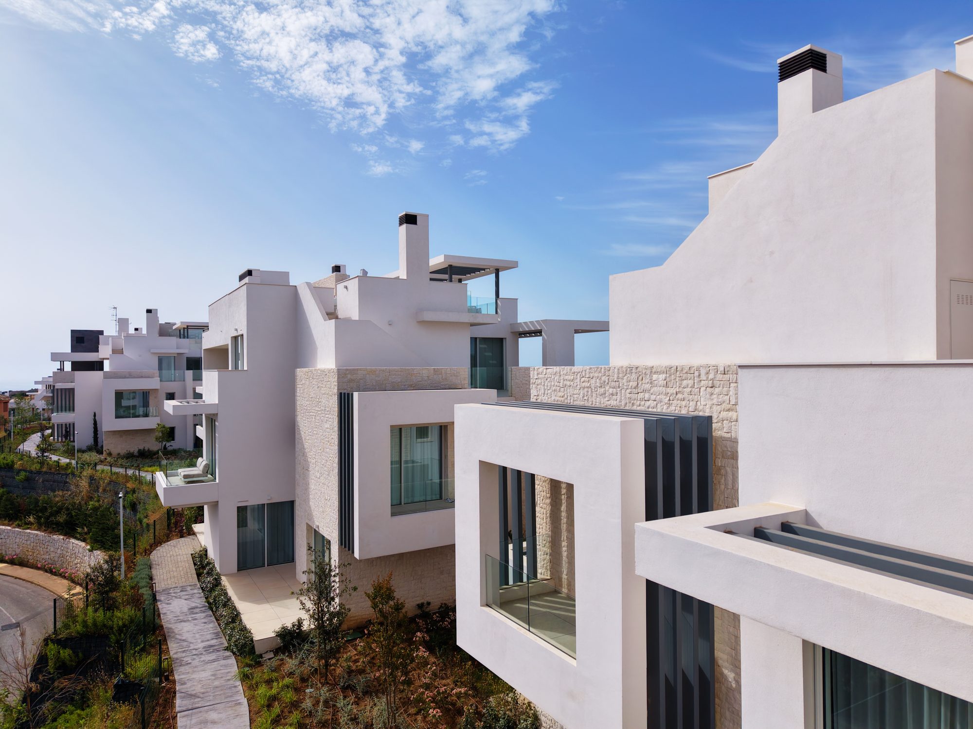 Close aerial of modern white villas