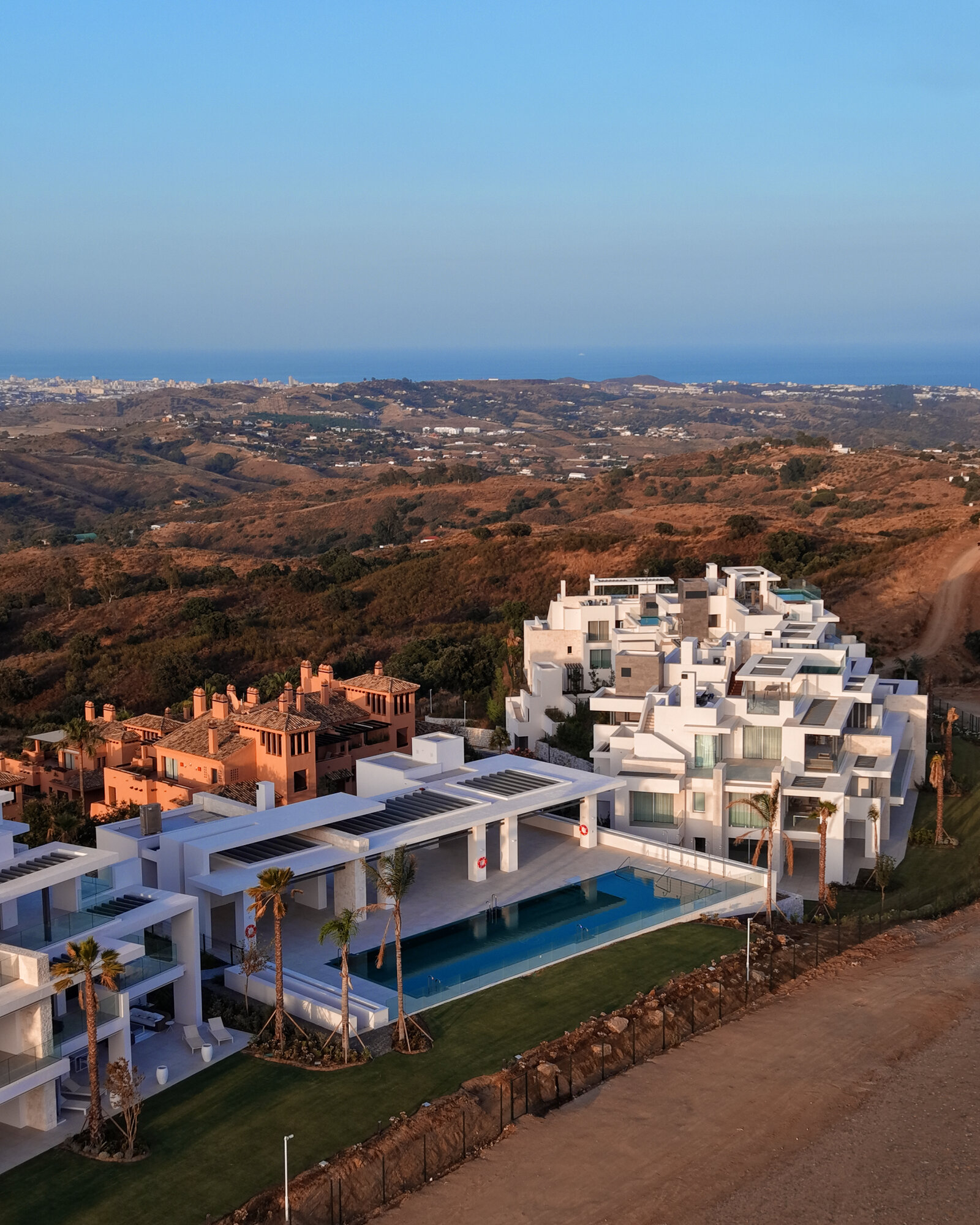 Aerial of pool villas and coastline