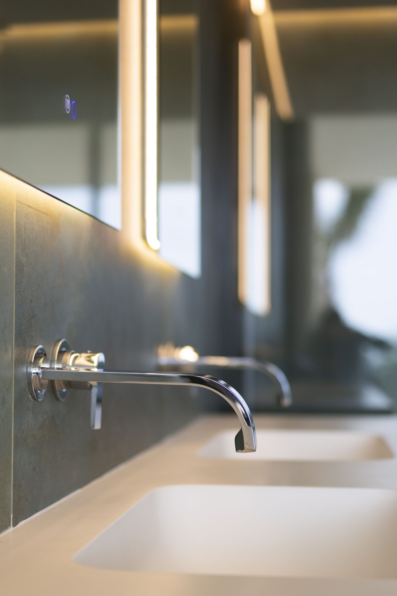 Wall-mounted tap over a stone basin