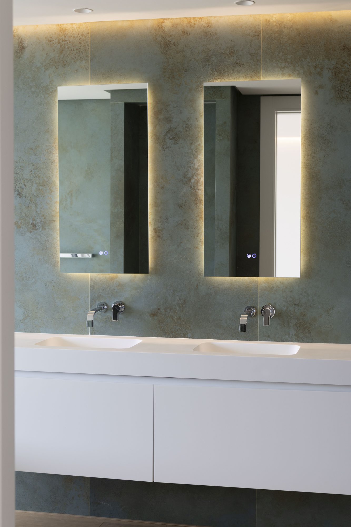 Backlit mirrors above a double basin