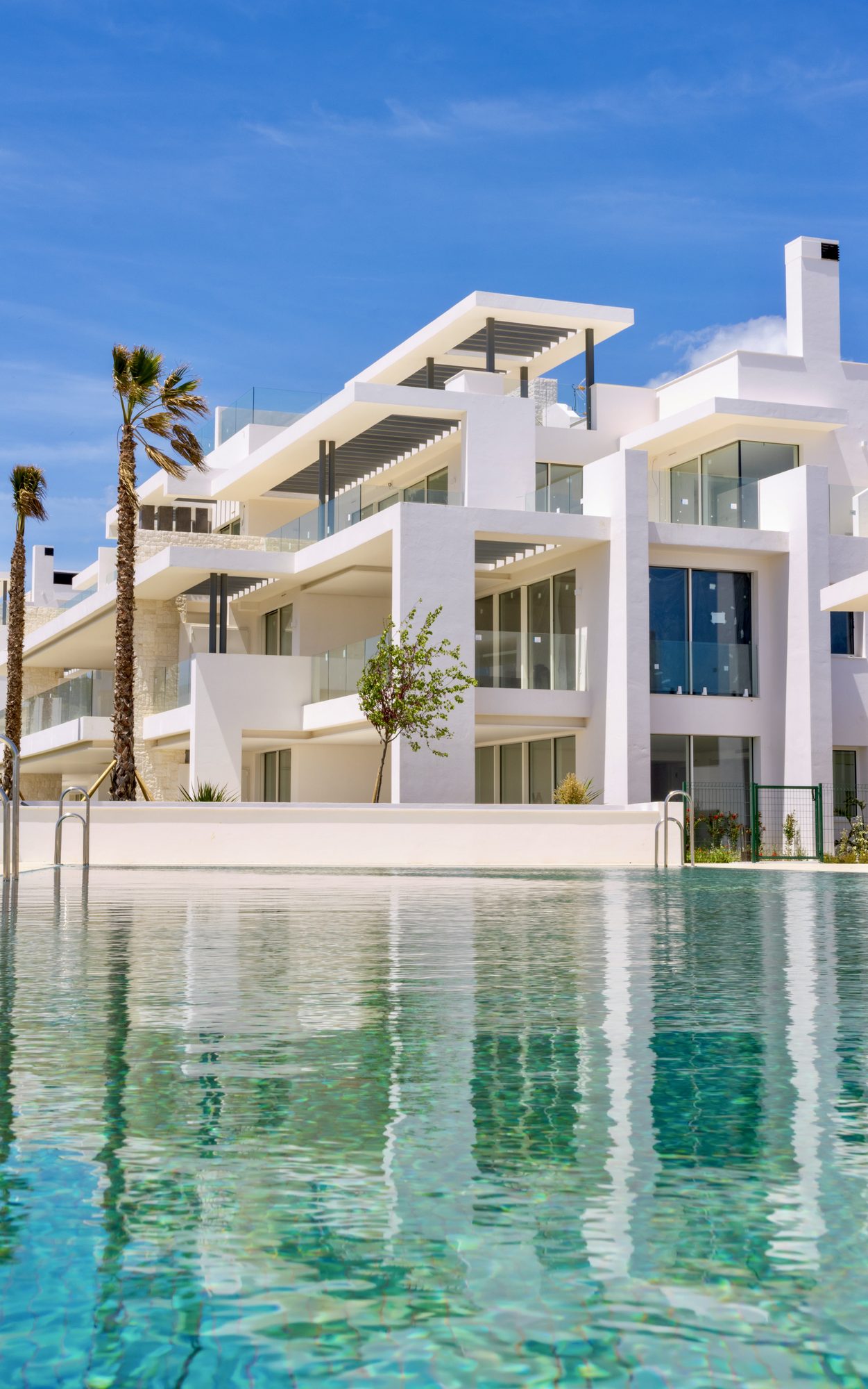White residential development reflected in a pool