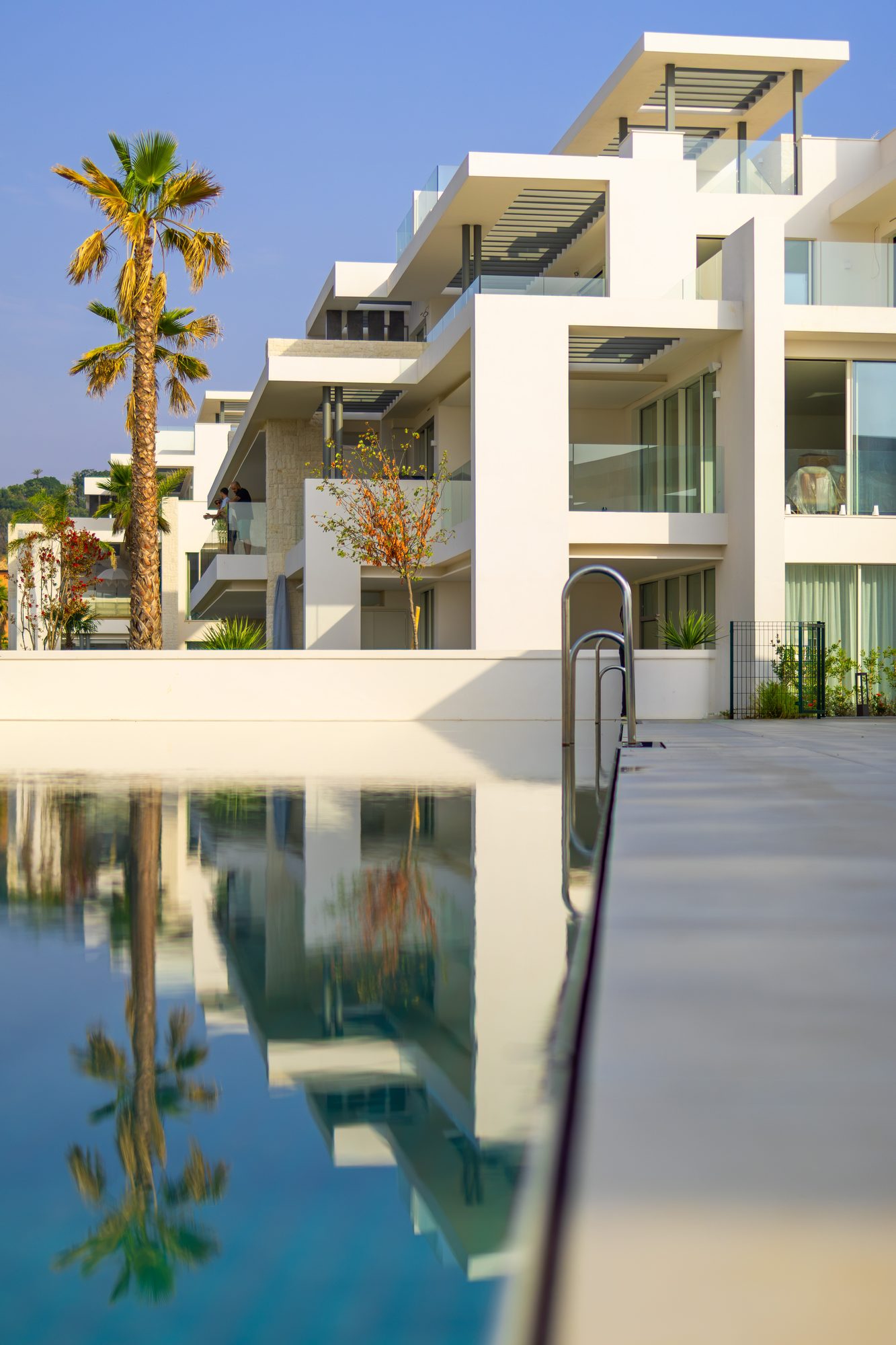 Villa facade reflected in a pool