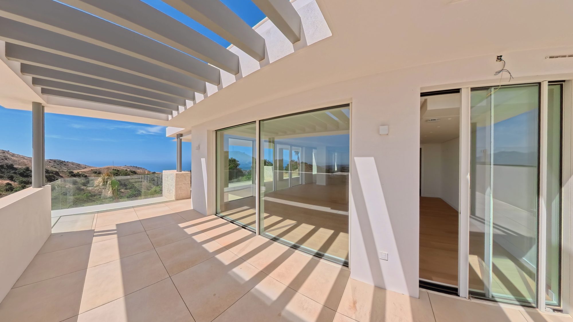 Terrace with pergola and sliding glass doors
