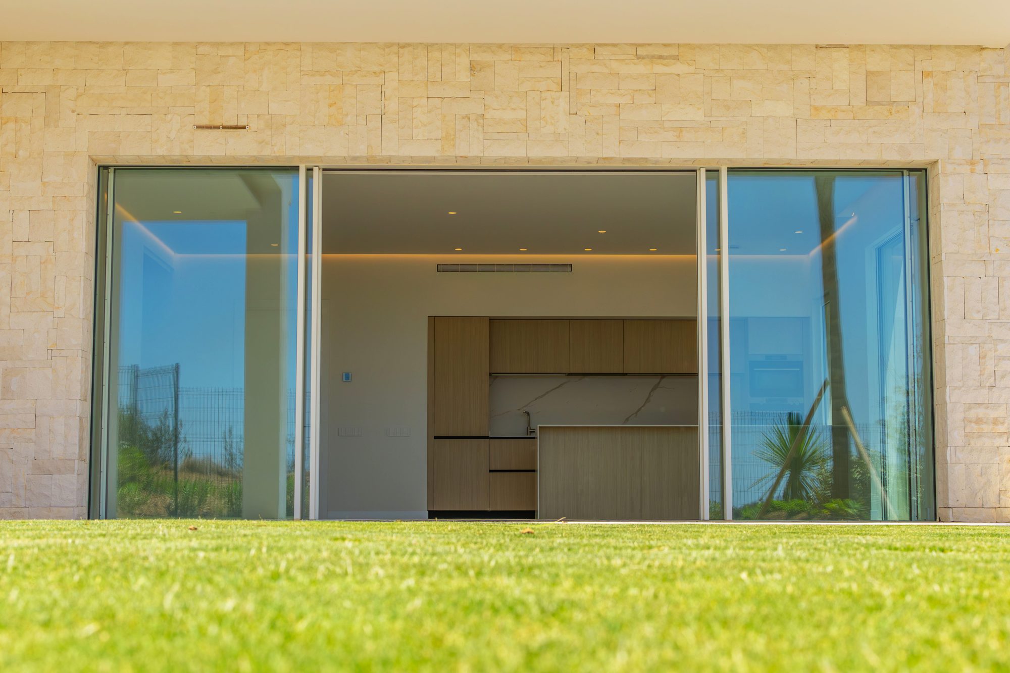 Ground-floor glass front opening onto a lawn