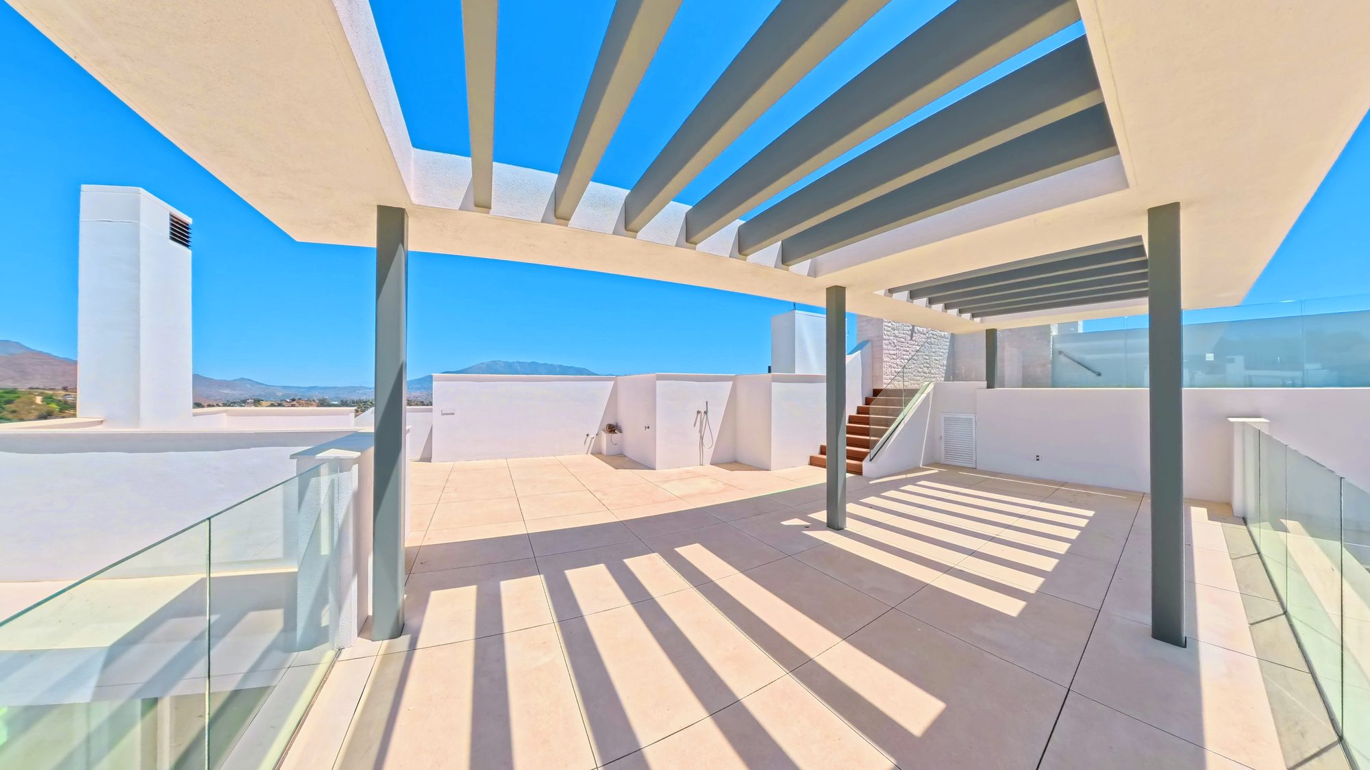 Pergola shadow lines on a terrace with a sea view