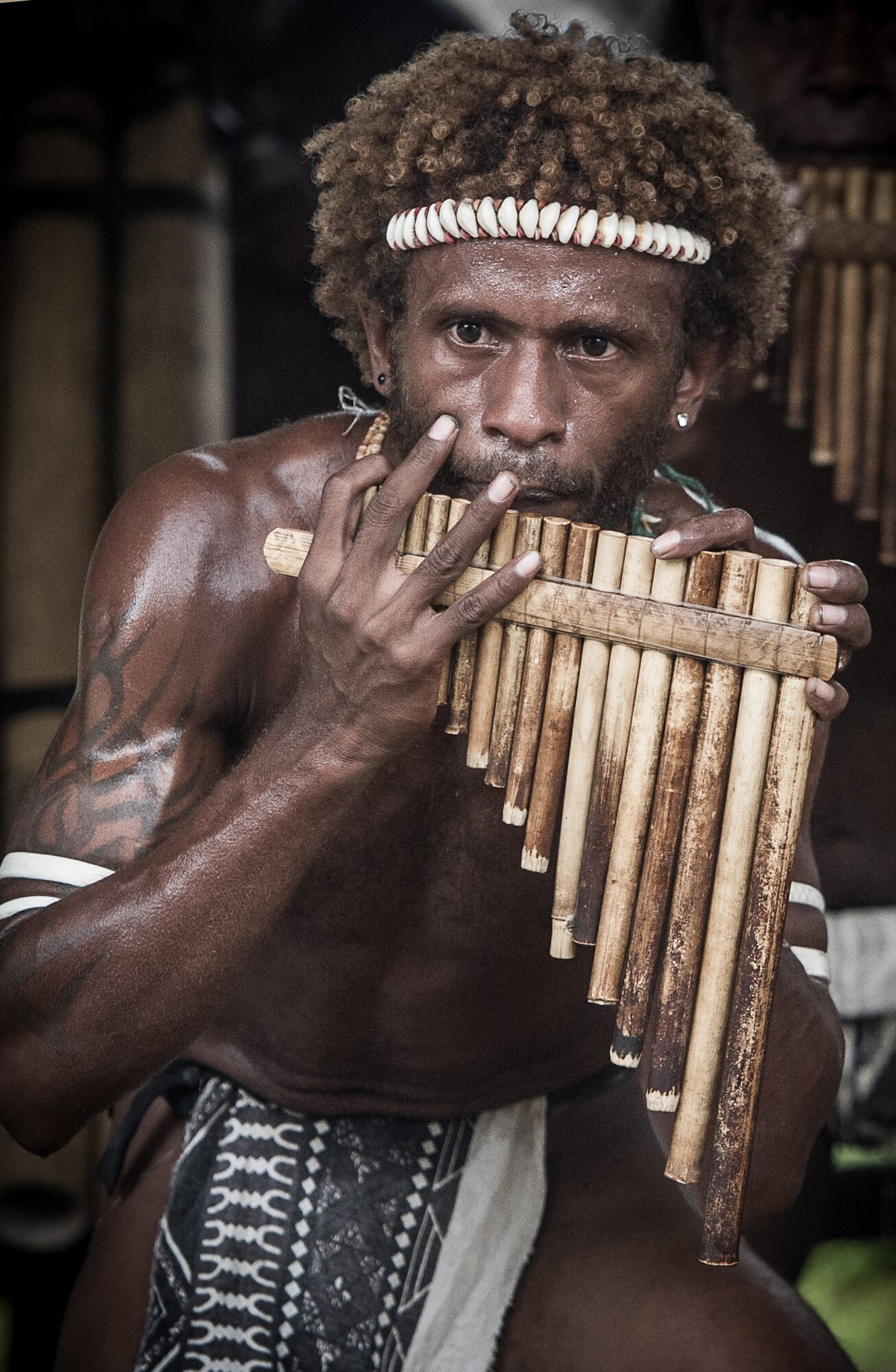 Musician playing pan flutes