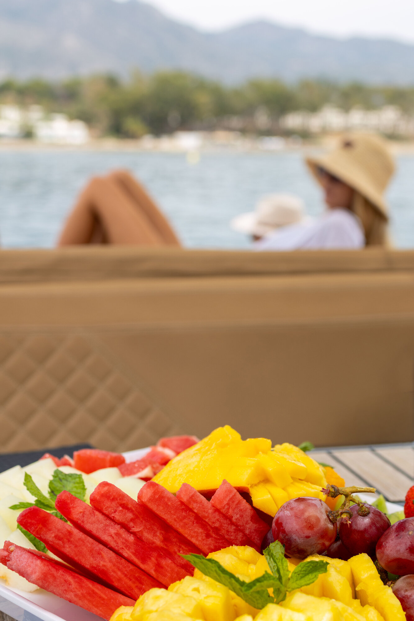 Fruit platter on board with guests