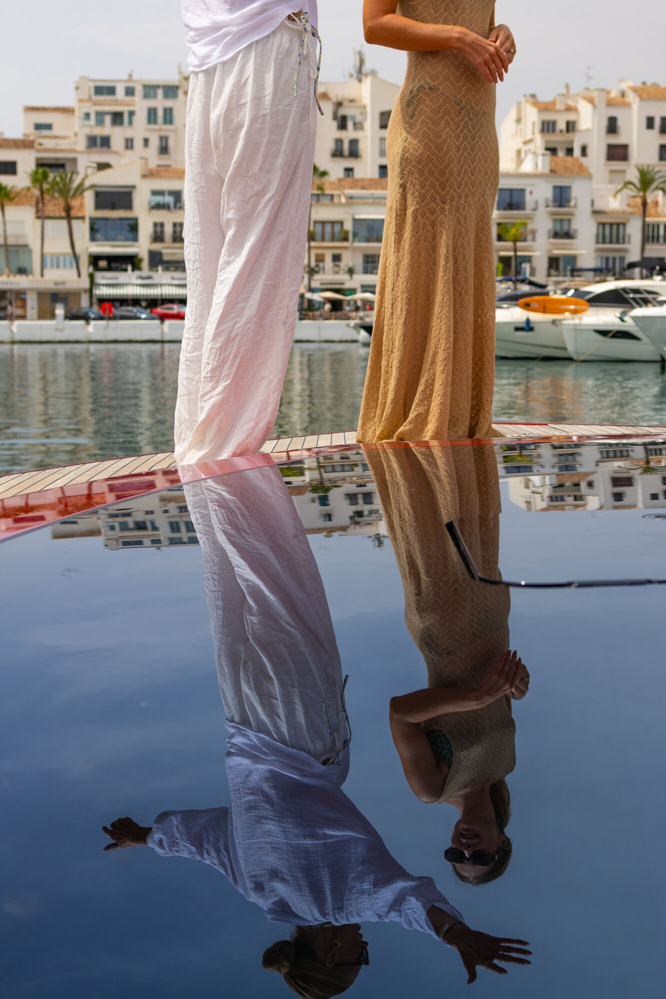 Two guests reflected in a glossy deck